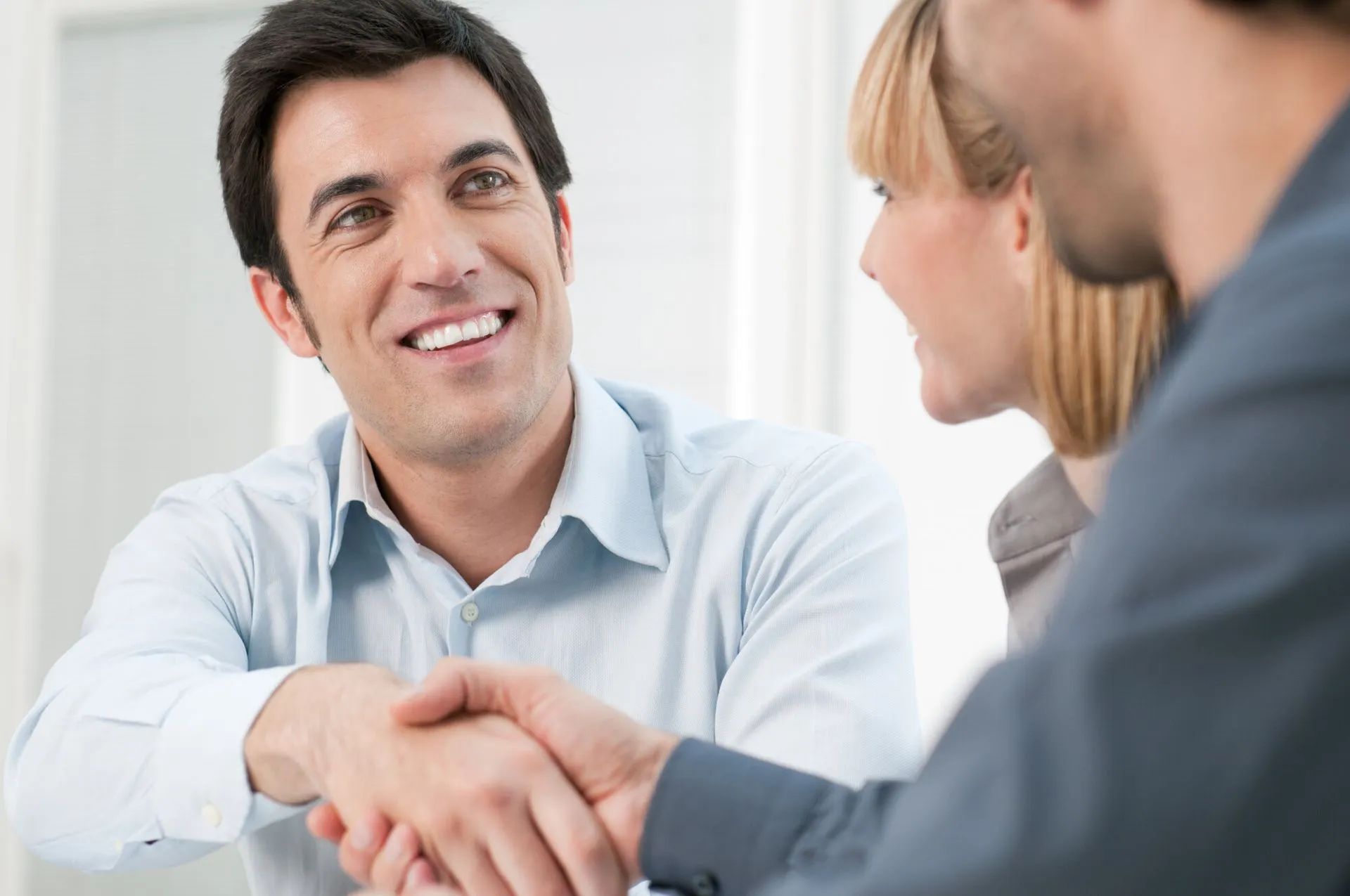 Local landlord shaking hands with a property manager after a Riverton, UT rental agreement.