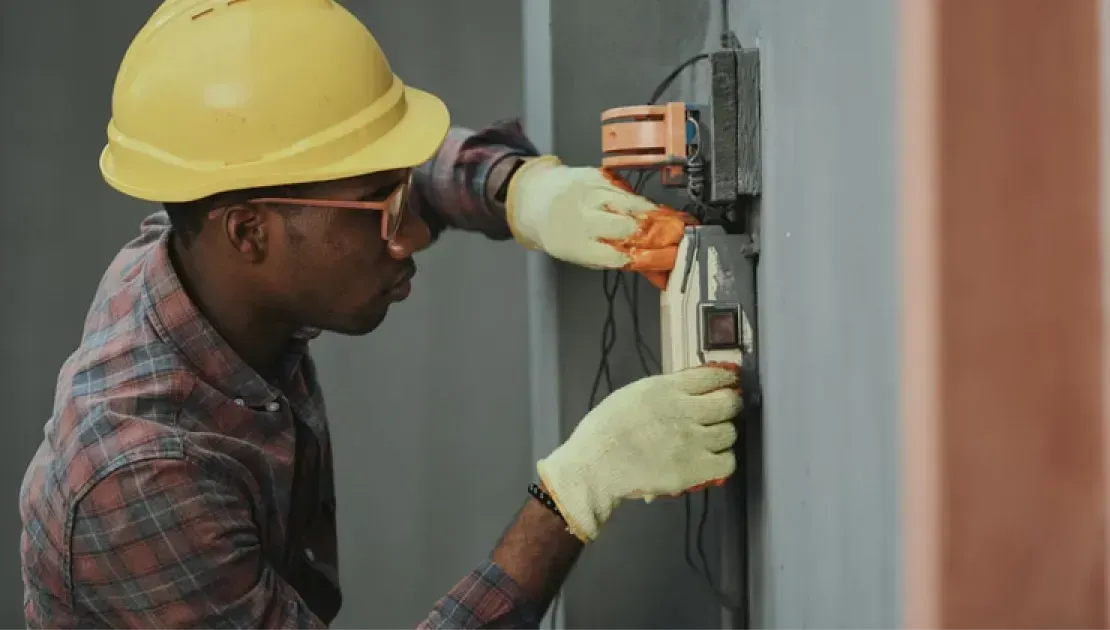 Maintenance technician inspecting mechanical systems in a West Valley City, UT rental home.