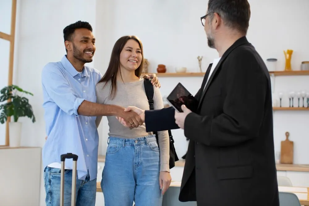 Vietnamese-speaking property manager shaking hands with a Sandy, UT rental homeowner.